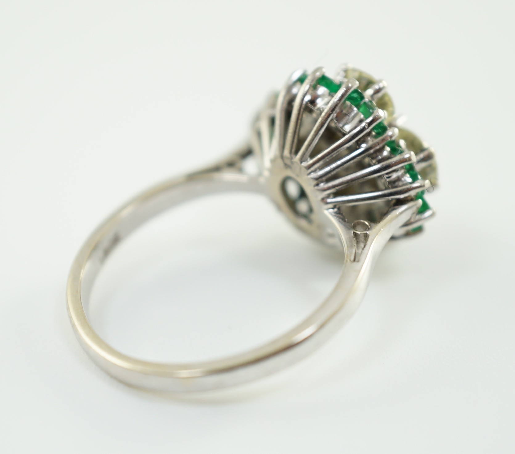 An 18ct white gold, emerald and diamond cluster set dress ring